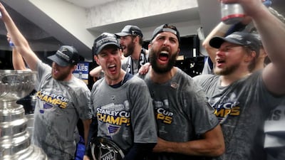 St. Louis Blues from left Brayden Schenn, Jordan Binnington, Joel Edmundson, Robert Bortuzzo and Vladimir Tarasenko, of Russia, right, celebrate with the Stanley Cup in the locker room after defeating the Boston Bruins in Game 7 of the NHL Stanley Cup Final in Boston. AP