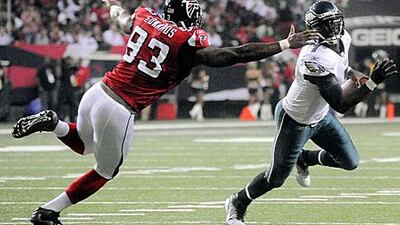 Michael Vick, the Eagles quarterback, is pursued by the Falcon's defensive end, Ray Edwards during Atlanta's 35-31 win against Philadelphia.