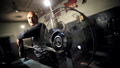 Cinema operator Rassoul winds a roll of film as he shows a Bollywood movie at Cinema Park in May 2012. AFP