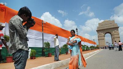 An Indian woman has her photo taken by a street photographer at the India Gate monument in New Delhi during Independence day celebrations on August 15, 2012. Roberto Schmidt / AFP Photo