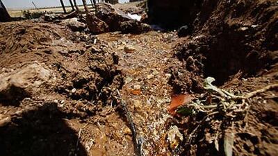 Water flows from a central pipe near the city of Madaba, south of Amman, in an aggression by farmers to irrigate their land.