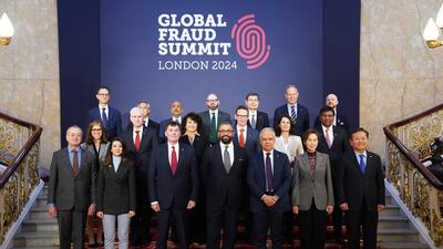 Home Secretary James Cleverly with delegates at the Global Fraud Summit at Lancaster House in London. PA