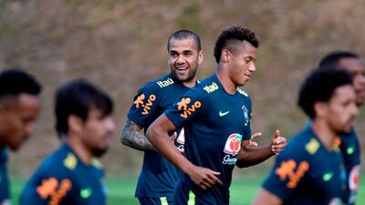 Brazil captain Dani Alves, centre, smiles as he and his teammates jog around the pitch. AFP
