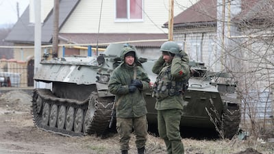 Soldiers loyal to Russia, but with insignia-free uniforms, in the separatist-controlled settlement of Bugas. Reuters