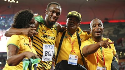 Usain Bolt celebrates with his coaches after winning the 100-metre world title on Sunday in Beijing. Lucy Nicholson / Reuters