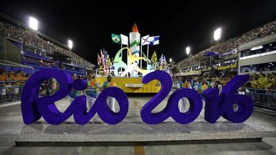 Participants push a Rio 2016 Olympics sign during the opening ceremony presenting the Samba Schools' parade at the Sambodromo of Rio de Janeiro in Rio de Janeiro, Brazil, on February 7, 2016. (EPA/MARCELO SAYAO)