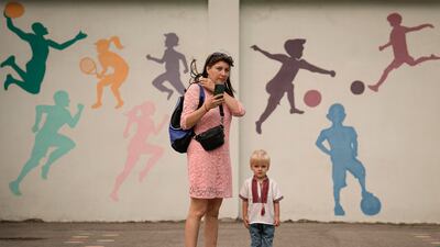 A Ukrainian refugee waits for a school opening ceremony in Bucharest, Romania. About 100 children started term on Thursday, the same day schools open in Ukraine but earlier than the official start in Romania. AP