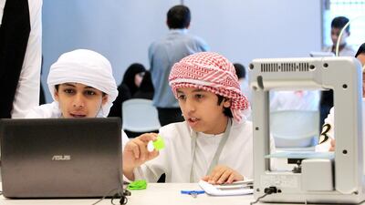 Pupils from schools in Abu Dhabi learn to use a 3-D printer during the Tech Quest camp at the Masdar Institute. Christopher Pike / The National