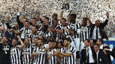 Juventus players celebrate with the Serie A trophy on Saturday after their win over Napoli. Valerio Pennicino / Getty Images