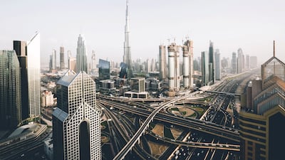 A birds-eye-view shot of the Sheikh Zayed Road and the Burj Khalifa in Dubai.