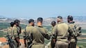 Israeli soldiers look towards Lebanon from the border. Reuters