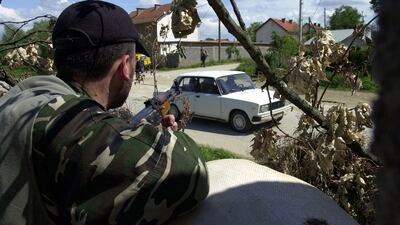 A rebel of the ethnic Albanian UCK movement mans a position on May 13, 2001 in the northern Macedonian town of Slupcane. Fighting ended with a Nato ceasefire monitoring force and the Albanian side agreed to give up separatist demands. AFP