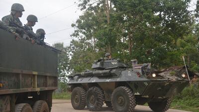 Philippine marines aboard an Amored Personnel Carrier (APC) and a truck guard a highway in Indanan town, Sulu province on the southern island of Mindanao on February 27, 2017, after reports of the beheading of German national Jurgen Kantner by the Abu Sayyaf group. - Islamic militants in the Philippines have beheaded the German hostage they were holding for ransom, the government in Manila said February 27. (Photo by NICKEE BUTLANGAN / AFP)