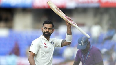 India captain Virat Kohli raises his bat to acknowledge the applause from the crowd at the end of the play on first day of the Test cricket match against Bangladesh in Hyderabad, India, on February 9, 2017. Aijaz Rahi / AP