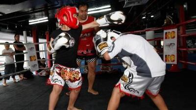 Roel Van Eijkeren, 8, of Holland, throws a punch as Rahmar Zikria, 8, of Afghanistan, ducks for safety during a sparring session.