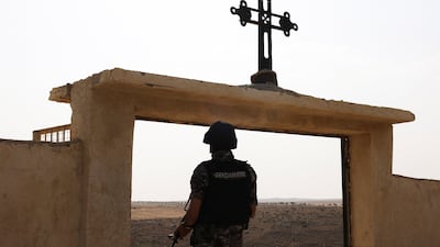 A soldier stands guard during preparations for the funeral of victims of a church shooting in Karak, Jordan. Reuters