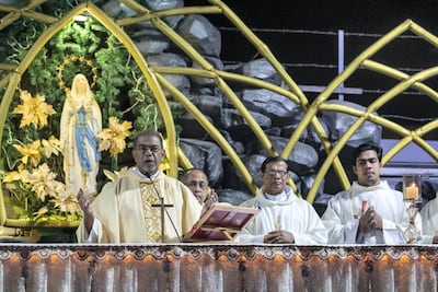 Father Lennie Connully speaks to worshippers on Christmas Eve. Antonie Robertson / The National