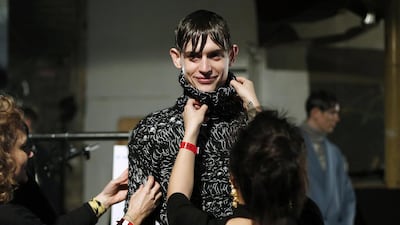 More than 130 designers showed off their wares at London’s men’s fashion week to international press and buyers from 37 countries. Above, assistants dress a model backstage during the event. Suzanne Plunkett / Reuters