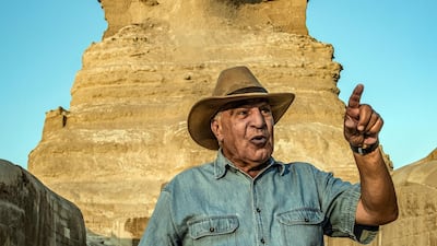 Zahi Hawass, Egyptian archaeologist and former antiquities minister, stands before the Great Sphinx of Giza during a lecture with a tourist group on ancient Egyptian history, at the Giza Necropolis on the southeastern outskirts of the capital on November 20, 2019. - The 72-year-old dubbed "the Egyptian Indiana Jones" revels in his reputation as an indefatigable yet controversial figure in the enigmatic world of Egyptology. Having appeared in dozens of documentaries about ancient Egypt, Hawass himself is a star attraction for a luxury archaeological tour organised by an operator based in Poland. He was head of Egypt's Supreme Council of Antiquities from 2002 to 2011 and then briefly minister of antiquities in early 2011, before leaving in a haze of corruption allegations along with other Mubarak allies. (Photo by Khaled DESOUKI / AFP)