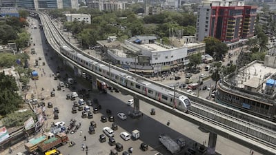 A metro train rides through Mumbai. The first phase of the 11.4 kilometres on the Versova-Andheri-Ghatkopar line has a total of 12 stations and is expected to carry about 11,00,000 passengers every day. Divyakant Solanki / EPA
