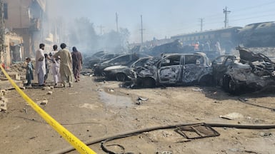 Security officials and rescuers gather near wrecked cars at the scene of a deadly explosion on the rail track in Quetta, Pakistan. EPA