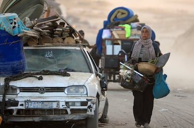 A Palestinian woman walks south on Saturday after Israeli forces ordered residents of Gaza city to leave. Reuters