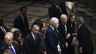 Former president George W. Bush, top right, greets (from left) US president Bill Clinton and Hillary Clinton, and former president Jimmy Carter and Rosalynn Carter during the funeral service for his father. AFP