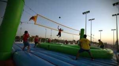 Players from Brazil and the Netherlands play bossaball, a new Brazilian sport, at the beach in Dubai yesteday.