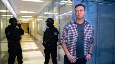 File photo: Russian opposition leader Alexei Navalny speaks to the media in front of security officers standing guard at the Foundation for Fighting Corruption office in Moscow, AP