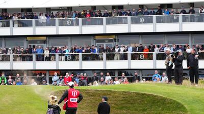 Rory McIlroy chips out of a bunker on the 15th. PA