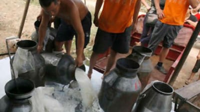 Milk is seen being poured away due to the closure of a milk factory on the outskirts of Wuhan, Hubei province Sept 21 2008.