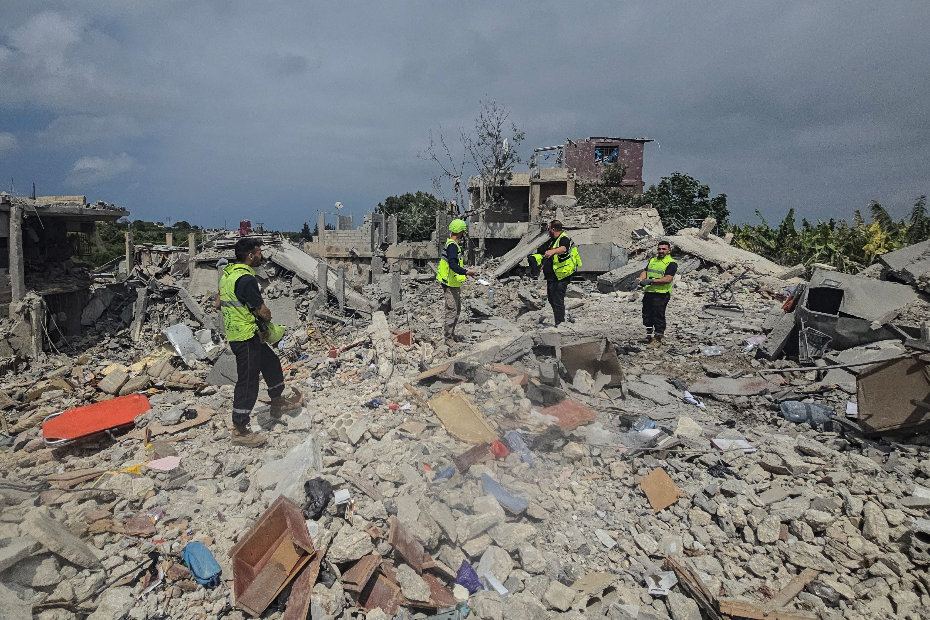 Civil defence members search for victims in the rubble in Burj Al Shamali. AFP