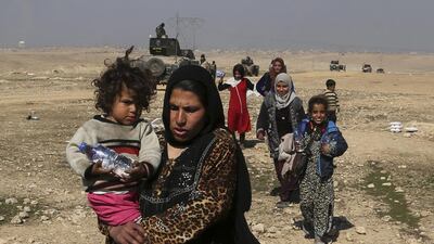 Iraqis flee fighting between government forces and ISIL militants on the western side of Mosul on February 23, 2017. Khalid Mohammed / AP Photo