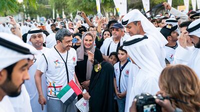 Sheikh Abdullah bin Zayed is accompanied by hundreds of people on the Walk of Tolerance in Umm Al Emarat Park, Abu Dhabi, in October. Wam