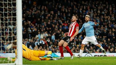 Manchester City's Sergio Aguero scores the first goal. Reuters