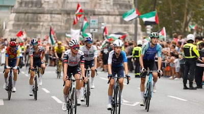 Riders sit up on their bikes after the race is called off. EPA