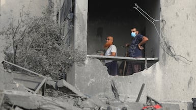 Palestinian men work at the site of an Israeli air strike on a house in Gaza City on October 16. Reuters