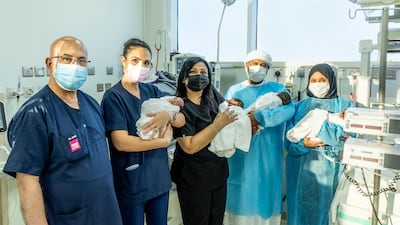 Roaya Tawakol, far right, with her husband, medical team and four babies, all delivered by caesarean at 29 weeks. Photo: Medcare Women & Children Hospital
