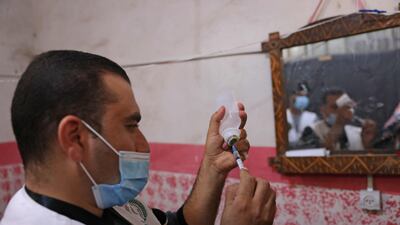 A medic prepares a Covid-19 vaccine dose during an inoculation campaign in the Palestinian city of Rafah. AFP