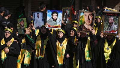 hezbollah women supporters march in Beirut holding pictures of relatives who were killed fighting in Syria October 1, 2017. AFP