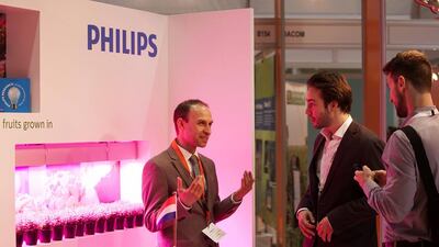 Visitors peruse a Philips exhibit during the Global Forum for Innovation in Agriculture. Silvia Razgova / The National