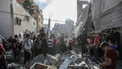 People search buildings destroyed during Israeli air strikes in Khan Younis, Gaza. Getty Images