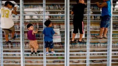 Children of foreign workers climb on a metal bookcase in Tel Aviv. As many as 1,200 children of such workers are at risk of deportation.