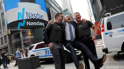 Lucid Motors' chief executive Peter Rawlinson takes photos with colleagues outside the Nasdaq MarketSite as the company begins trading on the Nasdaq stock exchange on Monday. Andrew Kelly / Reuters