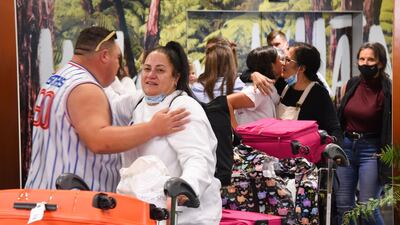 Emotional reunions after the first Air New Zealand flight into Wellington, New Zealand, touches down on the first day of the trans-Tasman bubble. EPA