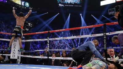 Juan Manuel Marquez celebrates as referee Kenny Bayless tend to a prone Manny Pacquiao in Las Vegas.