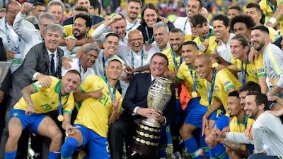 Brazilian President Jair Bolsonaro holds the Copa America trophy after Brazil won the 2019 tournament at Maracana Stadium in Rio de Janeiro. AFP