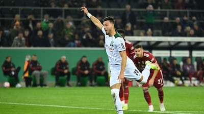 Moenchengladbach's Algerian defender Ramy Bensebaini scores the third from the penalty spot. AFP