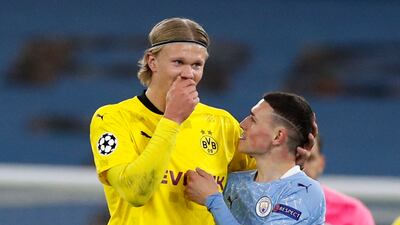 Borussia Dortmund's Erling Braut Haaland with Manchester City's Phil Foden after the match. Reuters
