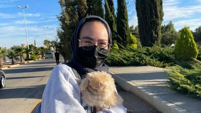 Aya Abu Zaid with with Nattouf, a cat belonging to a friend, at the Jordan University of Science and Technology in Irbid. Photo: Aya Abu Zaid